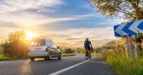 A bicycle and a car on the road